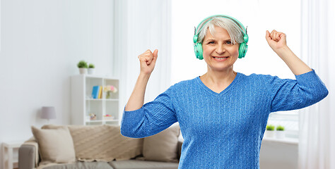 Image showing senior woman in headphones listening to music