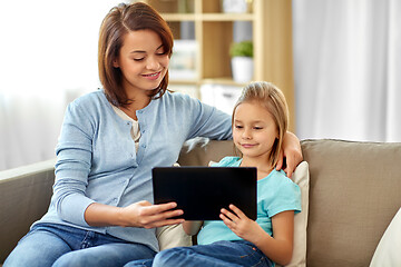 Image showing happy mother and daughter with tablet pc at home