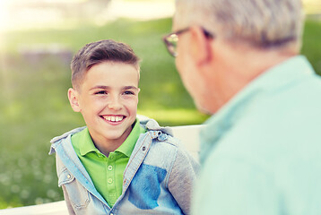 Image showing grandfather and grandson talking at summer park