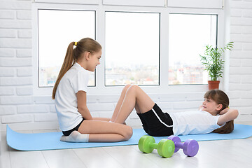 Image showing Sisters do sports exercises at home in self-isolation mode
