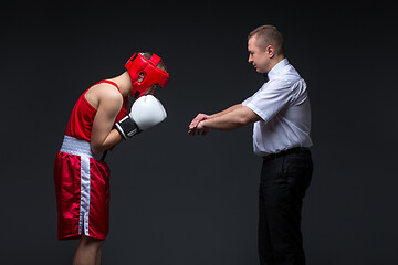 Image showing Referee checking young boxer