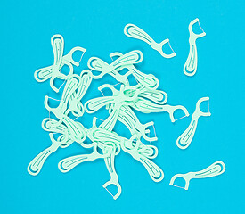 Image showing Floss toothpicks isolated on blue background