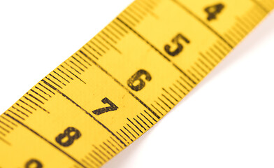 Image showing Close-up of a yellow measuring tape isolated on white - 7