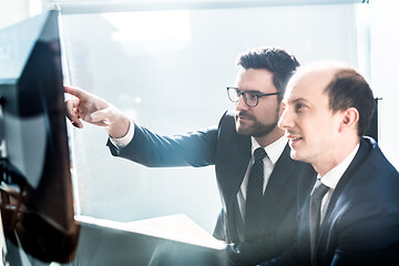 Image showing Business team analyzing data at business meeting in modern corporate office.