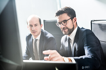 Image showing Business team analyzing data at business meeting in modern corporate office.