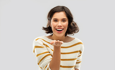 Image showing smiling woman holding something on empty palm