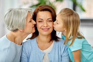 Image showing mother and daughter kissing happy grandmother