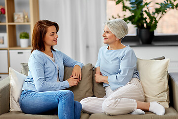 Image showing senior mother talking to adult daughter at home