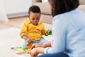 Image showing mother and baby playing with toy blocks at home