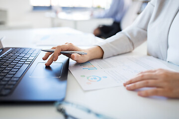 Image showing businesswoman with laptop working at office