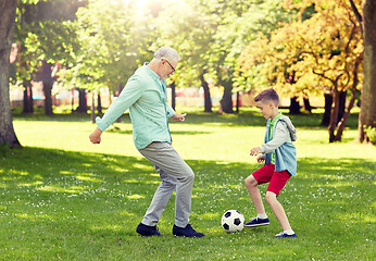 Image showing old man and boy playing football at summer park