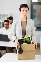 Image showing female office worker with box of personal stuff