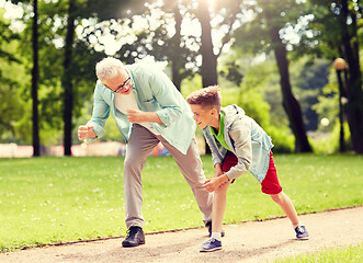 Image showing grandfather and grandson racing at summer park