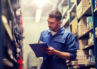 Image showing auto mechanic with clipboard at car workshop