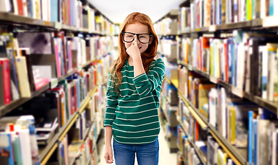 Image showing cute red haired student girl in glasses at library