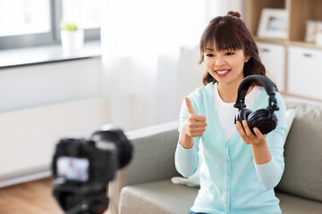 Image showing female blogger with headphones making video blog