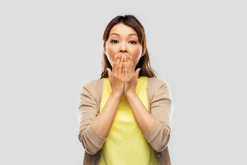 Image showing scared asian woman over grey background
