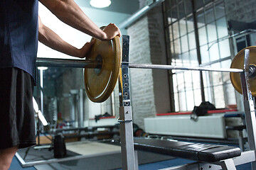 Image showing close up of man with barbell weight in gym