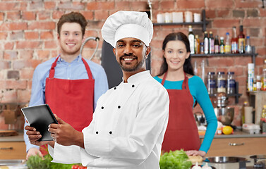 Image showing male indian chef with tablet pc at cooking class