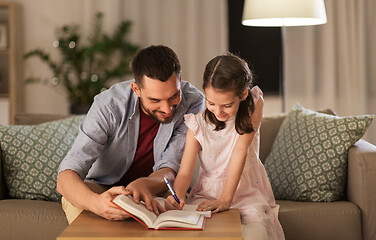 Image showing father and daughter doing homework together