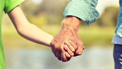 Image showing senior man and child holding hands