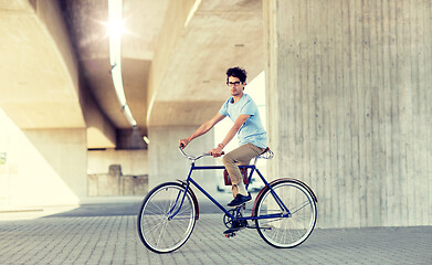 Image showing young hipster man riding fixed gear bike