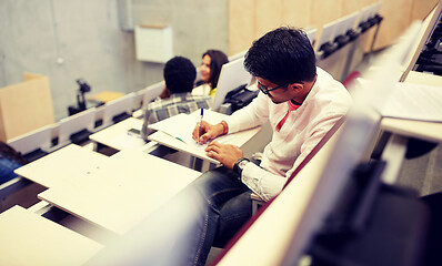 Image showing group of students with notebooks in lecture hall