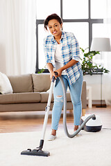 Image showing woman or housewife with vacuum cleaner at home