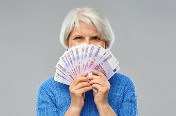 Image showing senior woman with hundreds of euro money banknotes