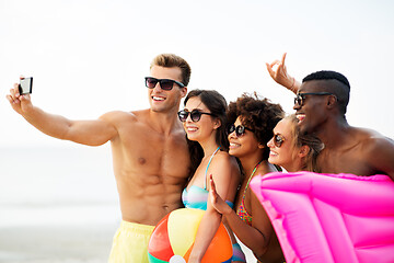 Image showing happy friends taking selfie on summer beach