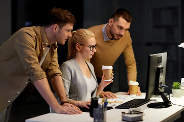 Image showing business team with computer working late at office