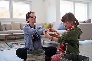 Image showing Mother and little girl daughter playing with jewelry  at home