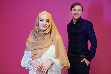 Image showing portrait of young muslim couple isolated on pink background