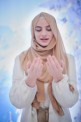 Image showing beautiful muslim woman making traditional prayer to God