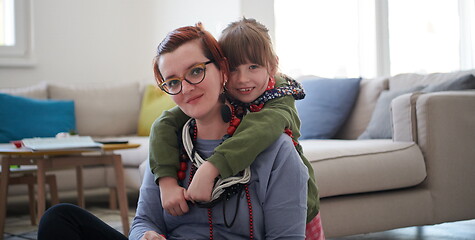 Image showing Mother and little girl daughter playing with jewelry  at home