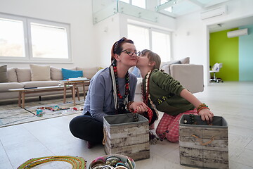 Image showing Mother and little girl daughter playing with jewelry  at home