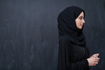 Image showing portrait of beautiful muslim woman in front of black chalkboard