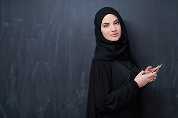 Image showing young modern muslim business woman using smartphone