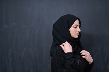 Image showing portrait of beautiful muslim woman in front of black chalkboard