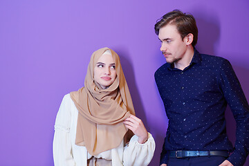 Image showing portrait of young muslim couple isolated on purple background