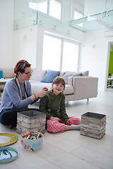 Image showing Mother and little girl daughter playing with jewelry  at home