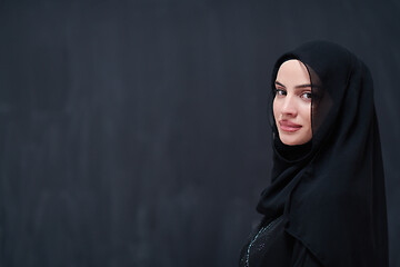 Image showing portrait of beautiful muslim woman in front of black chalkboard