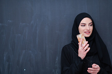 Image showing young modern muslim business woman using smartphone