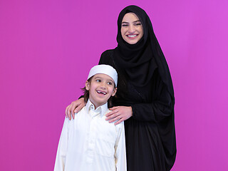 Image showing portrait of muslim mother and son on pink background