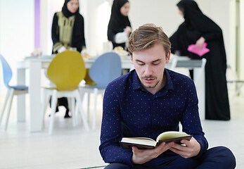 Image showing young muslim man reading Quran at home