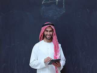 Image showing young arabian muslim businessman using tablet computer