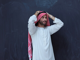 Image showing portrait of arabian man in front of black chalkboard