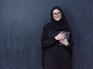 Image showing young muslim business woman using tablet computer