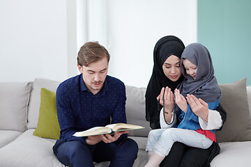 Image showing muslim family reading Quran and praying at home