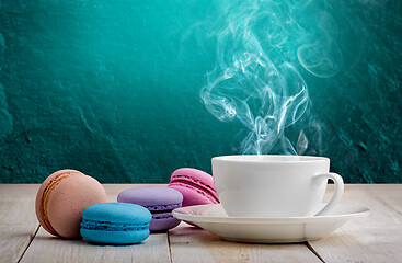 Image showing Macaroons with coffee turquoise background